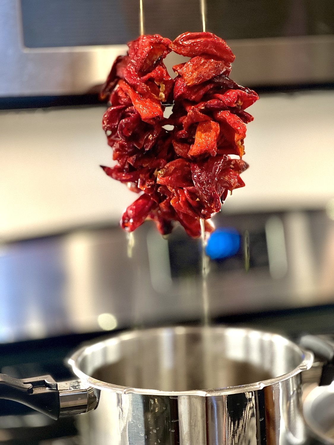 Sun-dried red peppers over the pot